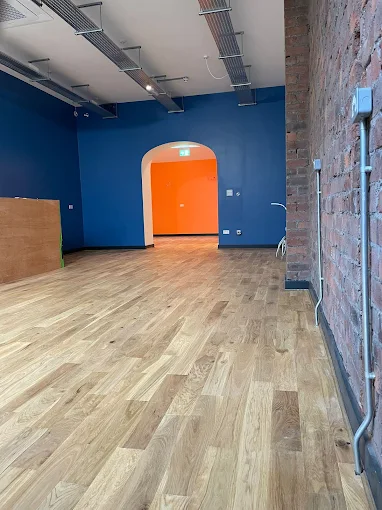 Commercial unit finished in deep navy by Home Hues with an arched opening painted bold orange