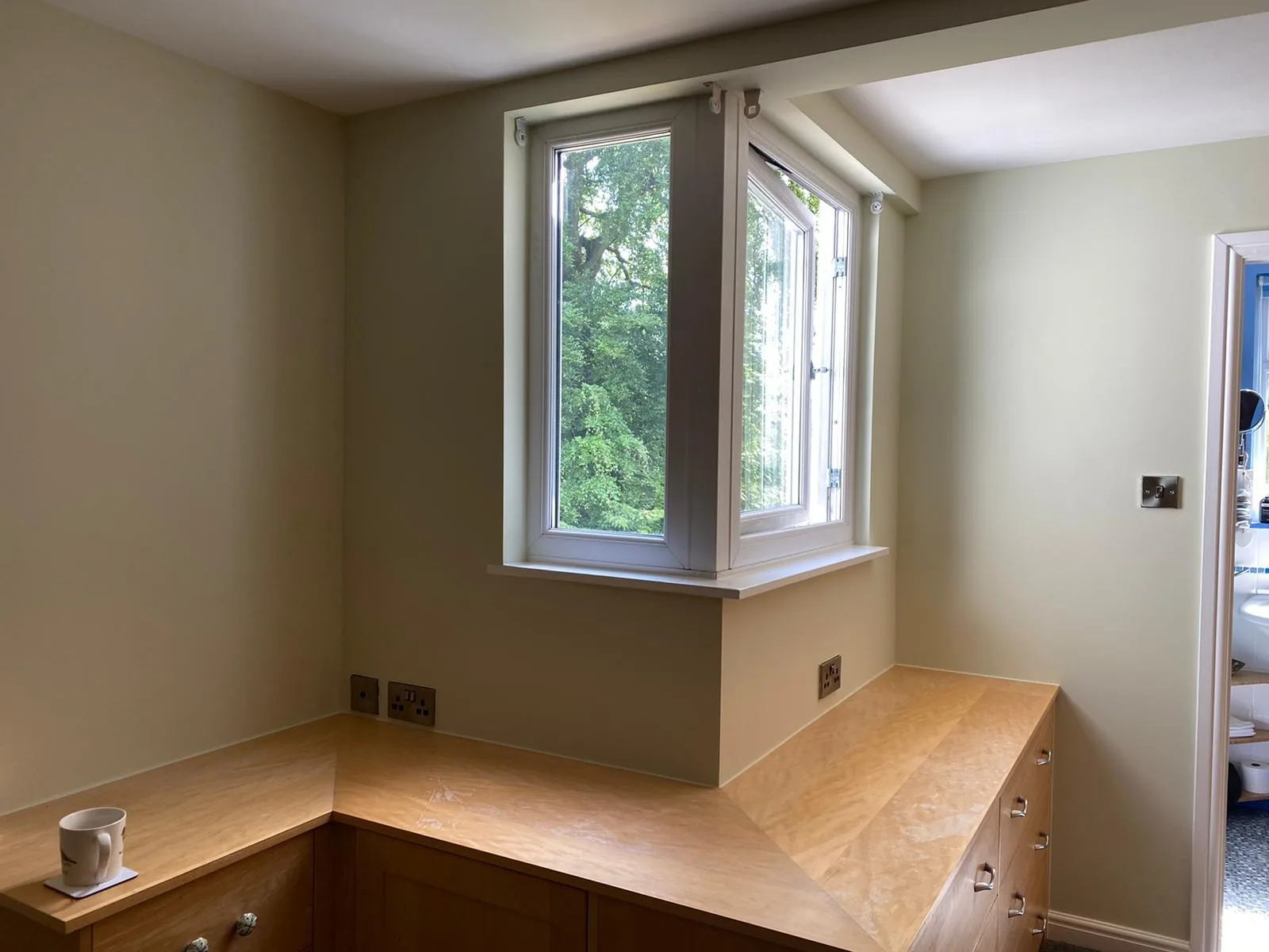 Same kitchen alcove finished by Home Hues in soft sage with crisp white woodwork